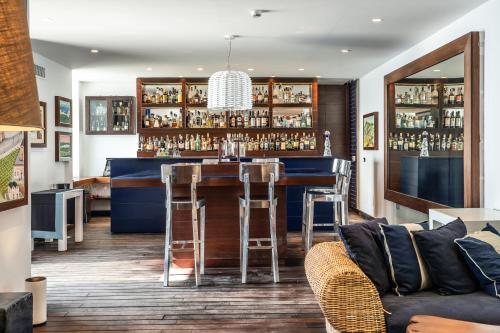 a bar in a room with a couch at Capo la Gala Hotel&Wellness in Vico Equense