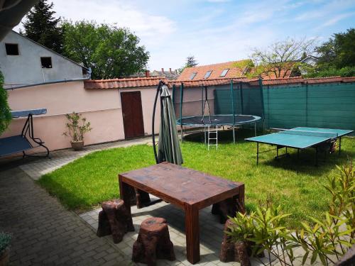 a patio with a table and a ping pong table at Levendula Apartman in Makó