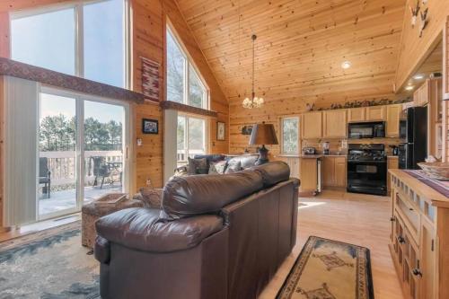 a living room with a leather couch and a kitchen at Cozy House in Quiet place. in Wisconsin Dells