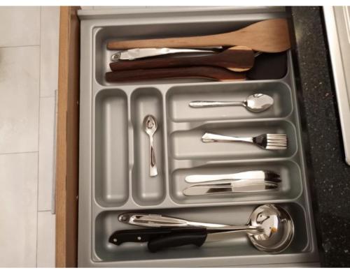 a tray of utensils in a drawer in a kitchen at Owen Studio in Diani Beach