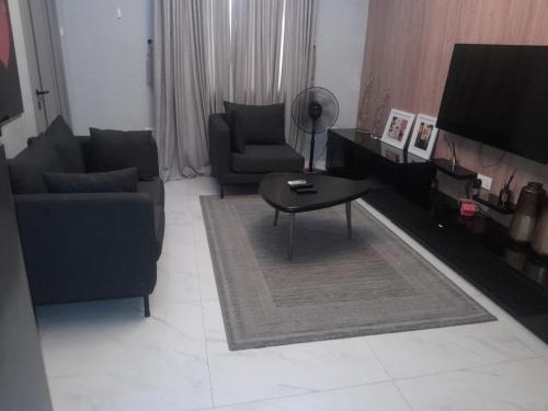 a living room with a couch and a table at HAS Shortlet in Lekki