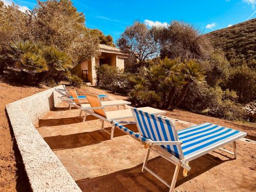 a group of lawn chairs sitting on the ground at Villa sul Mare Calalunga Calasetta Sant Antioco in Calasetta