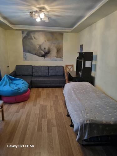 a living room with a couch and a bed at Happy 1 in Tbilisi City