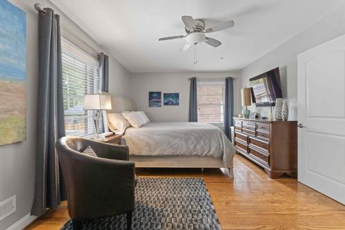 a bedroom with a bed and a chair and a window at Cozy Hub near Louisville's Attractions w Office in Louisville