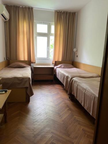a room with two beds and a window at Hotel Briz 3 - Free Parking in Varna City