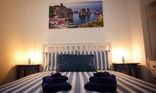 a bedroom with a bed with towels on it at Villa Ginevra in Balestrate