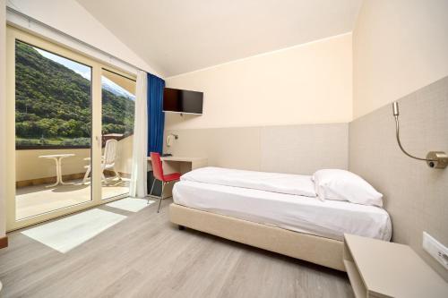 a hotel room with a bed and a large window at Hotel Astoria - 3stelle S in Malcesine