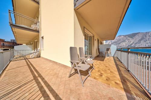 a balcony with chairs and a view of the ocean at Hotel Astoria - 3stelle S in Malcesine