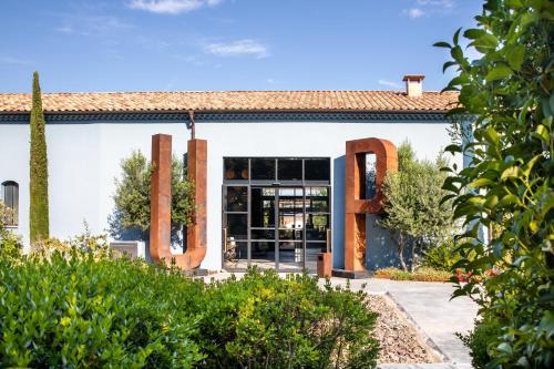 a building with large metal letters in front of it at Ultimate Provence Hotel & Spa in La Garde-Freinet