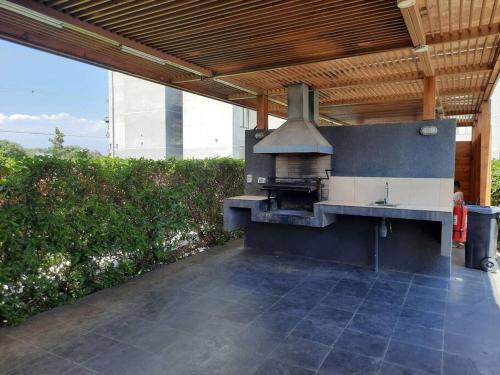 an outdoor kitchen with a stove in a patio at Departamento SUR, tu hogar, tu espacio in Santiago