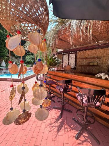 a patio with a table and chairs and umbrellas at Hotel Chateau de Ville in Marmaris