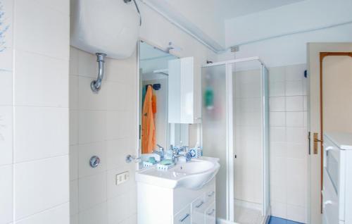 a white bathroom with a sink and a shower at Lovely Apartment In Villarosa Di Martinsicuro in Villa Rosa