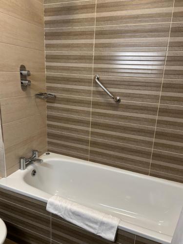 a white bath tub in a bathroom with a sink at Aherlow House Hotel & Lodges in Aherlow