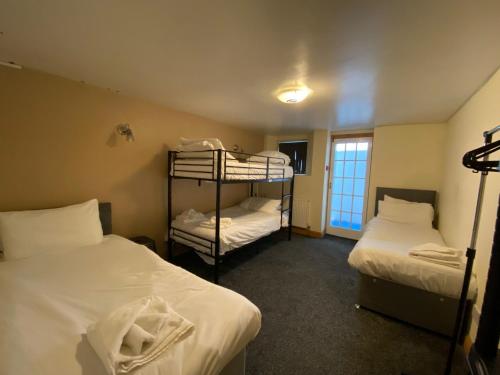 a room with two bunk beds and a window at Palatine Court Holiday Flats - Blackpool Resort Collection in Blackpool