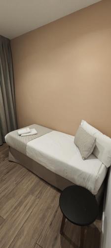 a bed in a small room with a table at New Point Opera in Madrid