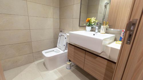 a bathroom with a white sink and a toilet at Aaderi super Studio in Dubai