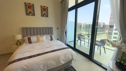 a bedroom with a bed and a balcony with a table at Aaderi super Studio in Dubai