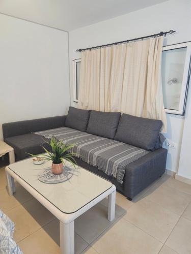 een woonkamer met een bank en een tafel bij Monda Apartment in Piraeus