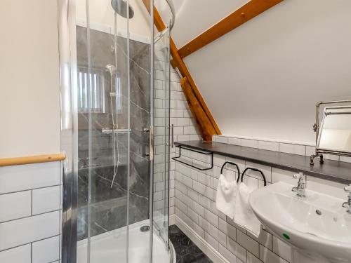 a bathroom with a shower and a sink at Little Barn At Bradwell Hall in Great Yarmouth