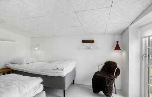 a bedroom with two beds and a chair at Lovely Home In Thisted With Wifi in Thisted