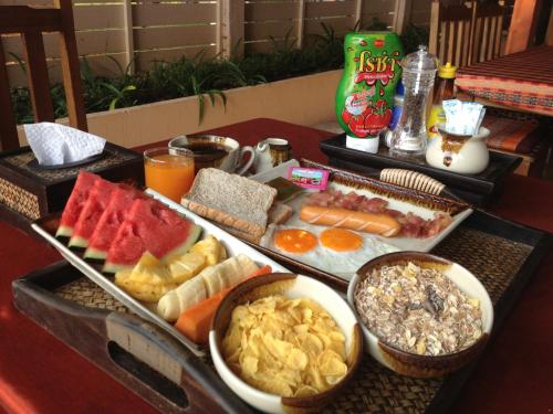 a table with a tray of different types of food at Nautilus Right on the Beach - Adult Only - SHA Extra Plus in Ko Lanta