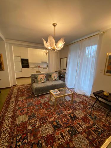 a living room with a couch and a rug at Villa Ani in Ascona