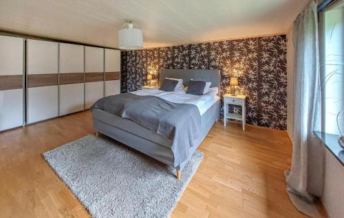 a bedroom with a bed and two lamps and a rug at 1 Bedroom Amazing Home In Hörby in Hörby