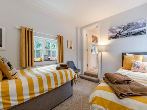 a bedroom with two beds and a window at Westmoor Annexe in Hereford