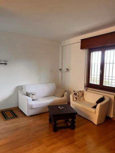 a living room with a white couch and a coffee table at Andrea’s Lake View House - Bellagio in Civenna