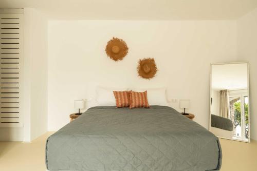 a bedroom with a bed and a large mirror at Tagoo Studios Mykonos in Mýkonos City