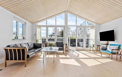 a living room with a couch and a table at Amazing Home In Frederikshavn in Frederikshavn