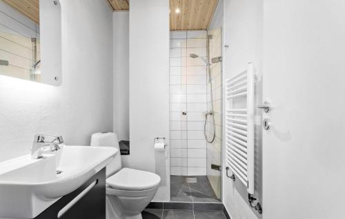 a bathroom with a toilet and a sink and a shower at 3 Bedroom Beautiful Home In Frederikshavn in Frederikshavn