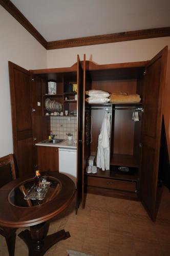 a kitchen with a table and a cupboard at Margit Suites Hotel in Karpenision