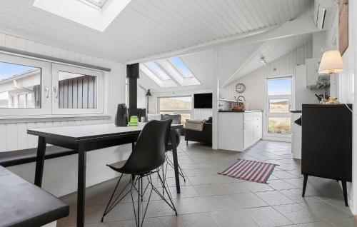 a kitchen with a table and chairs in a room at Beach Front Home In Hjørring With Sauna in Hjørring