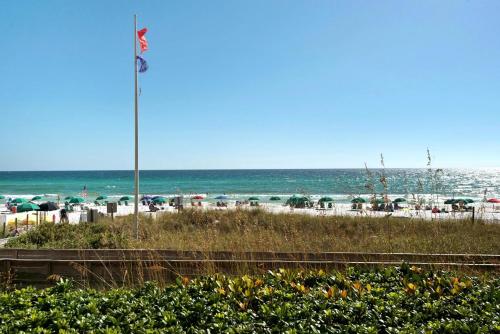 a beach with an american flag and the ocean at Edgewater #303 in Destin