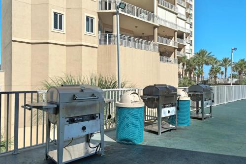 a row of grill and trash cans in front of a building at Edgewater #303 in Destin