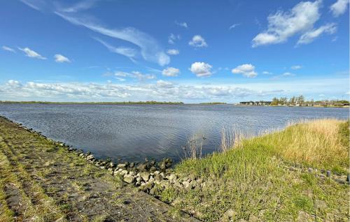 a large body of water with rocks in the water at Pet Friendly Home In Lauwersoog in Lauwersoog