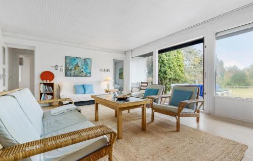 a living room with a couch and chairs and a table at 3 Bedroom Stunning Home In Vejby in Vejby