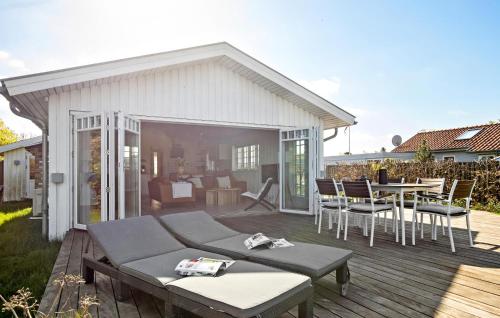 a patio with a table and chairs on a deck at Three-Bedroom Holiday Home In Knebel in Knebel