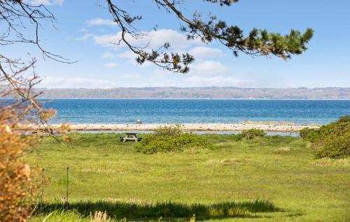 a picnic table on a beach near the water at Three-Bedroom Holiday Home In Knebel in Knebel
