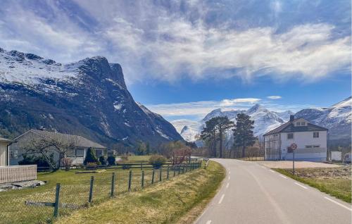 a road with a house and mountains in the background at 2 Bedroom Gorgeous Apartment In Eresfjord in Nauste