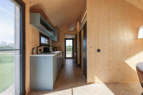ヴェストカペレにあるHello Zeeland - Tiny House Zeeuwse Liefde 2の木の壁の家の中のキッチン