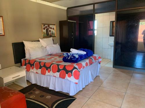 a bedroom with a bed and a bathroom at M & J HOTELS in Johannesburg