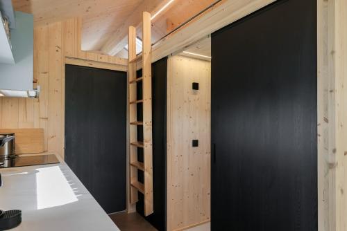 een kamer met zwarte muren en een stapelbed bij Hello Zeeland - Tiny House Zeeuwse Liefde 2 in Westkapelle