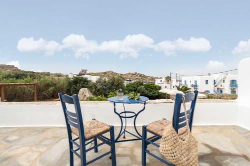 a table and two chairs on a patio at Tagoo Studios Mykonos in Mýkonos City