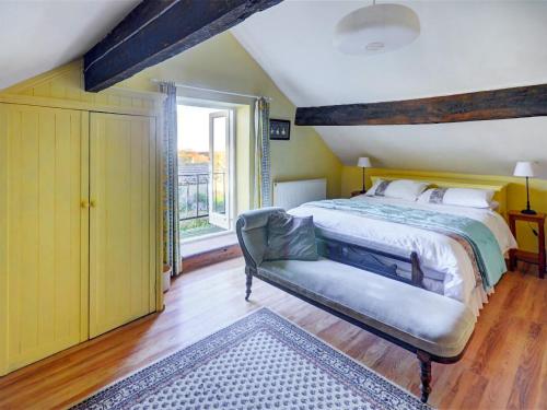 a bedroom with a large bed and a window at Uk47176 - Vine Barn in Bellerby