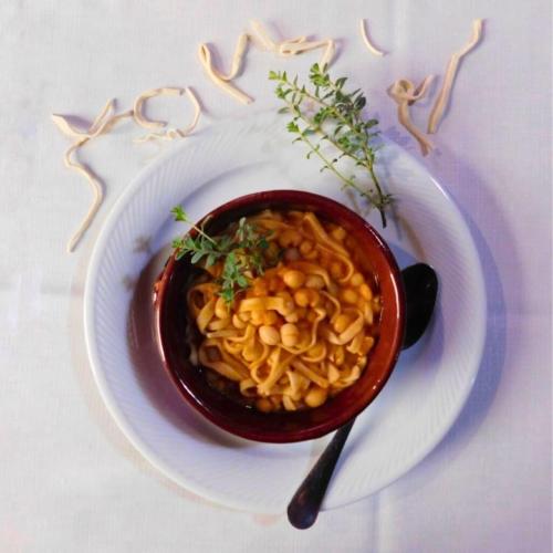 a bowl of pasta on a plate with a spoon at Il Borgo Ospitale - Albergo Diffuso in Rotonda