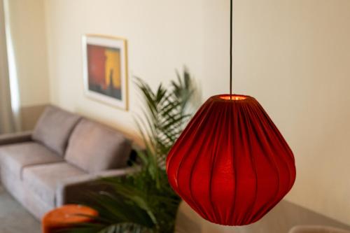 a red lamp in a living room with a couch at Solna Park & Hotel in Solna