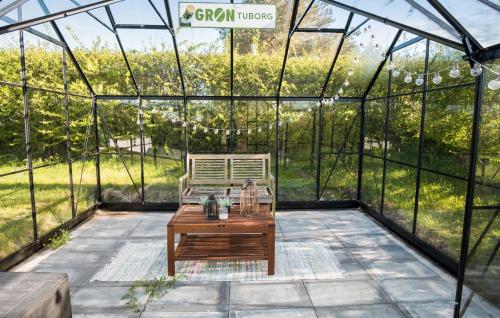 a greenhouse with a wooden table in it at 2 Bedroom Cozy Home In Haarby in Hårby