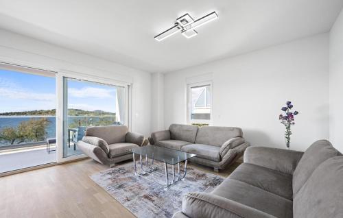 a living room with two couches and a table at Gorgeous Apartment In Vodice With Wifi in Vodice